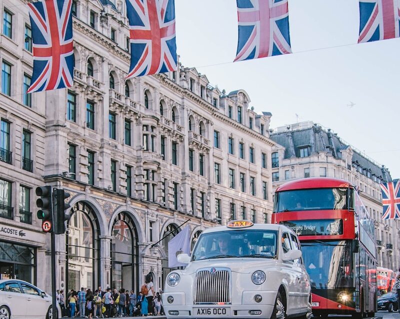 photo of car and bus near castle